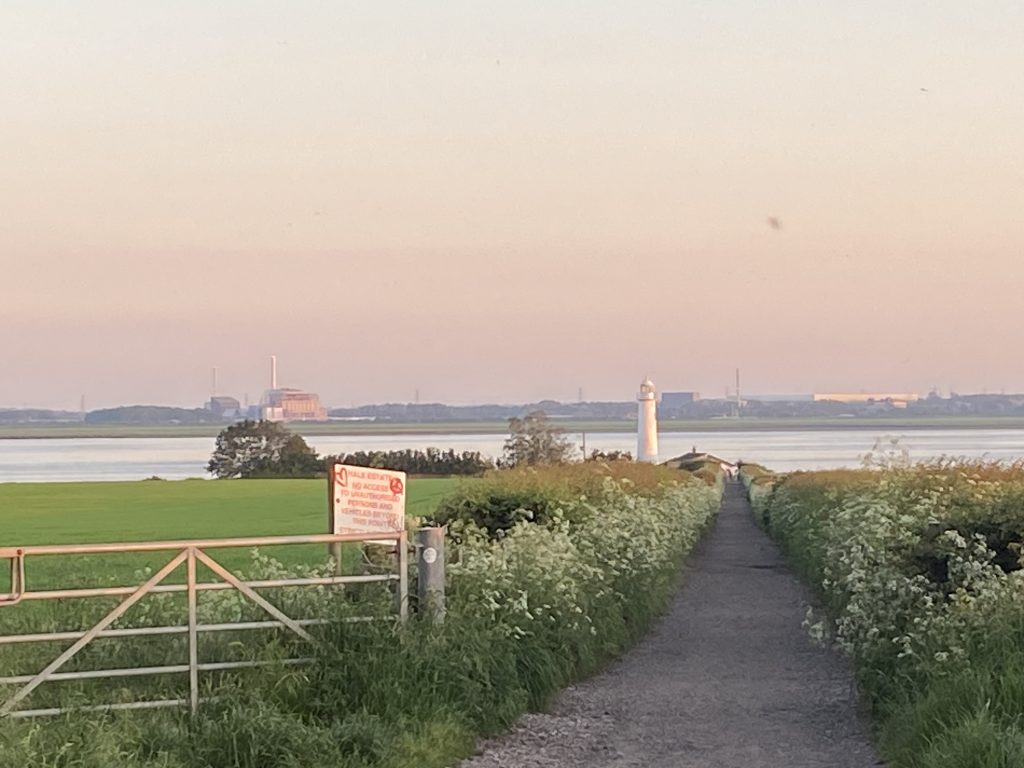 View down the track to Hale Lighthouse with the River Mersey in the background